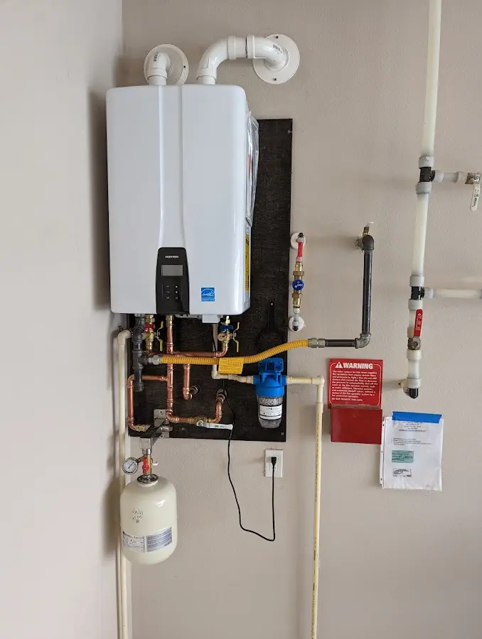 Professional plumber installing copper piping in a Dillonvale home